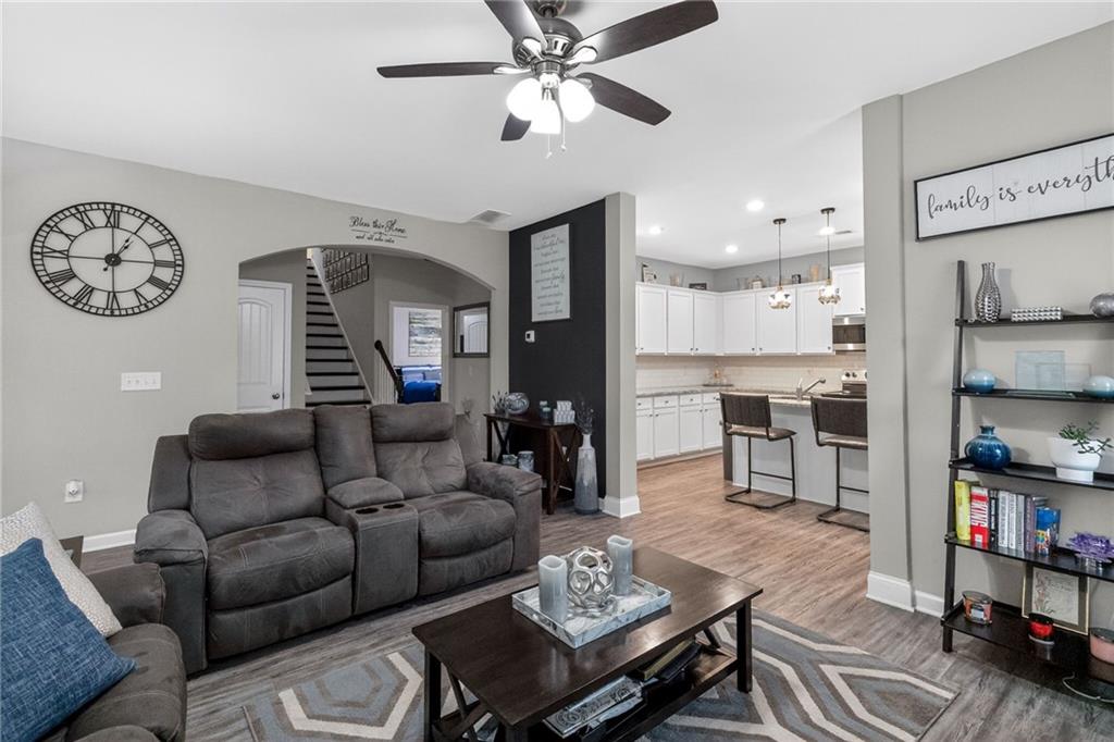 353 Daffodil Drive Temple, GA 30179 - Photo 9 of 30 a living room with furniture a rug and a kitchen view