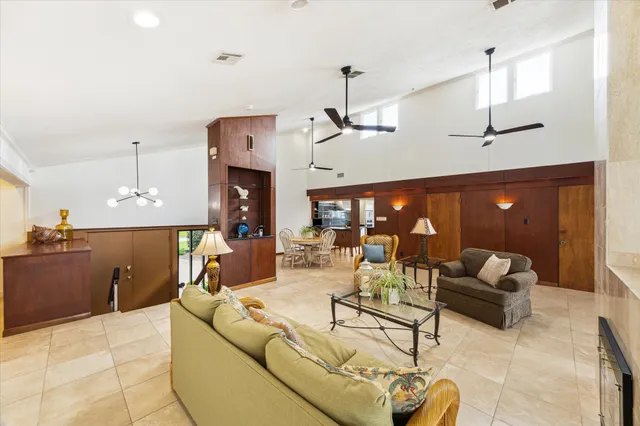 a living room with furniture and a ceiling fan