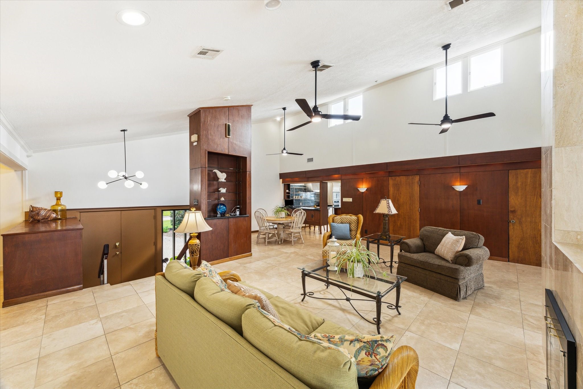 2414 Baycrest Drive Houston, TX 77058 - Photo 18 of 48 a living room with furniture a chandelier and a large window