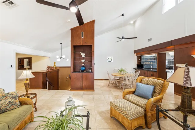 a dining room with furniture and a floor to ceiling window