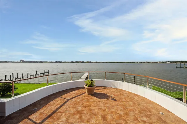 a view of a lake with couches in the patio