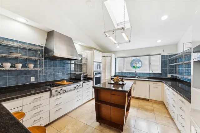 a kitchen with stainless steel appliances granite countertop a stove and a sink