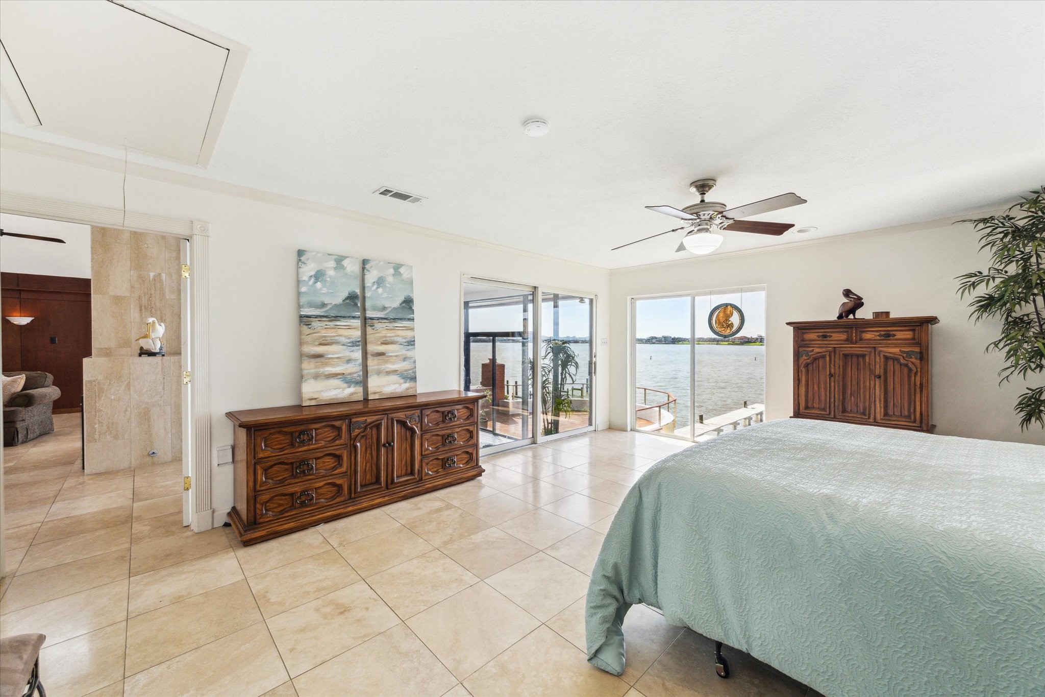 2414 Baycrest Drive Houston, TX 77058 - Photo 27 of 48 a spacious bedroom with a large bed and a chandelier