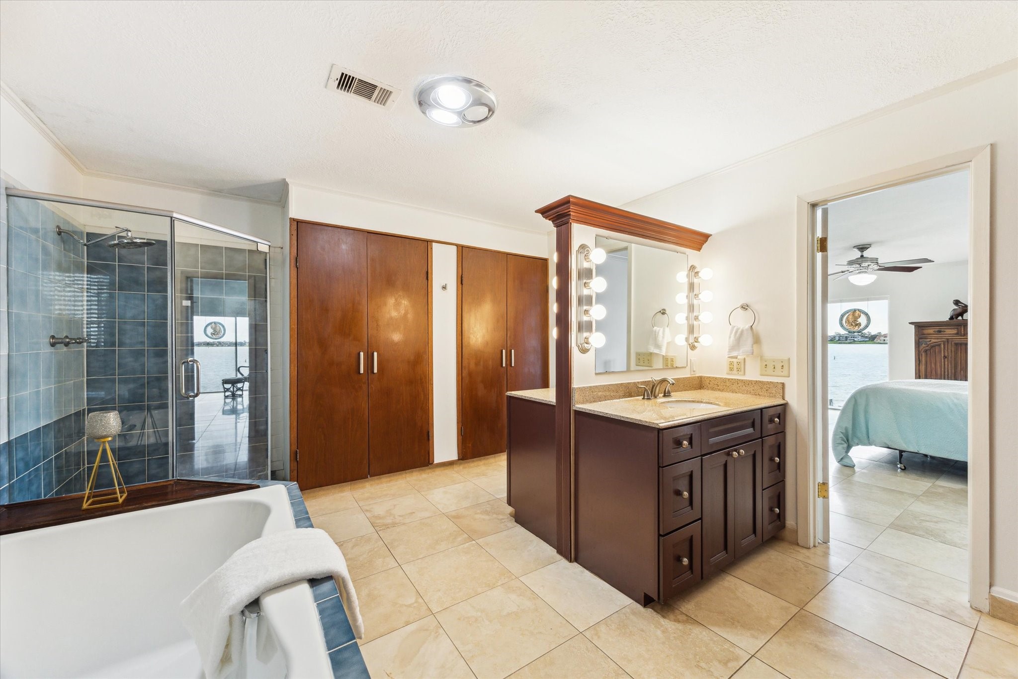 2414 Baycrest Drive Houston, TX 77058 - Photo 28 of 48 a spacious bathroom with a granite countertop tub sink and mirror