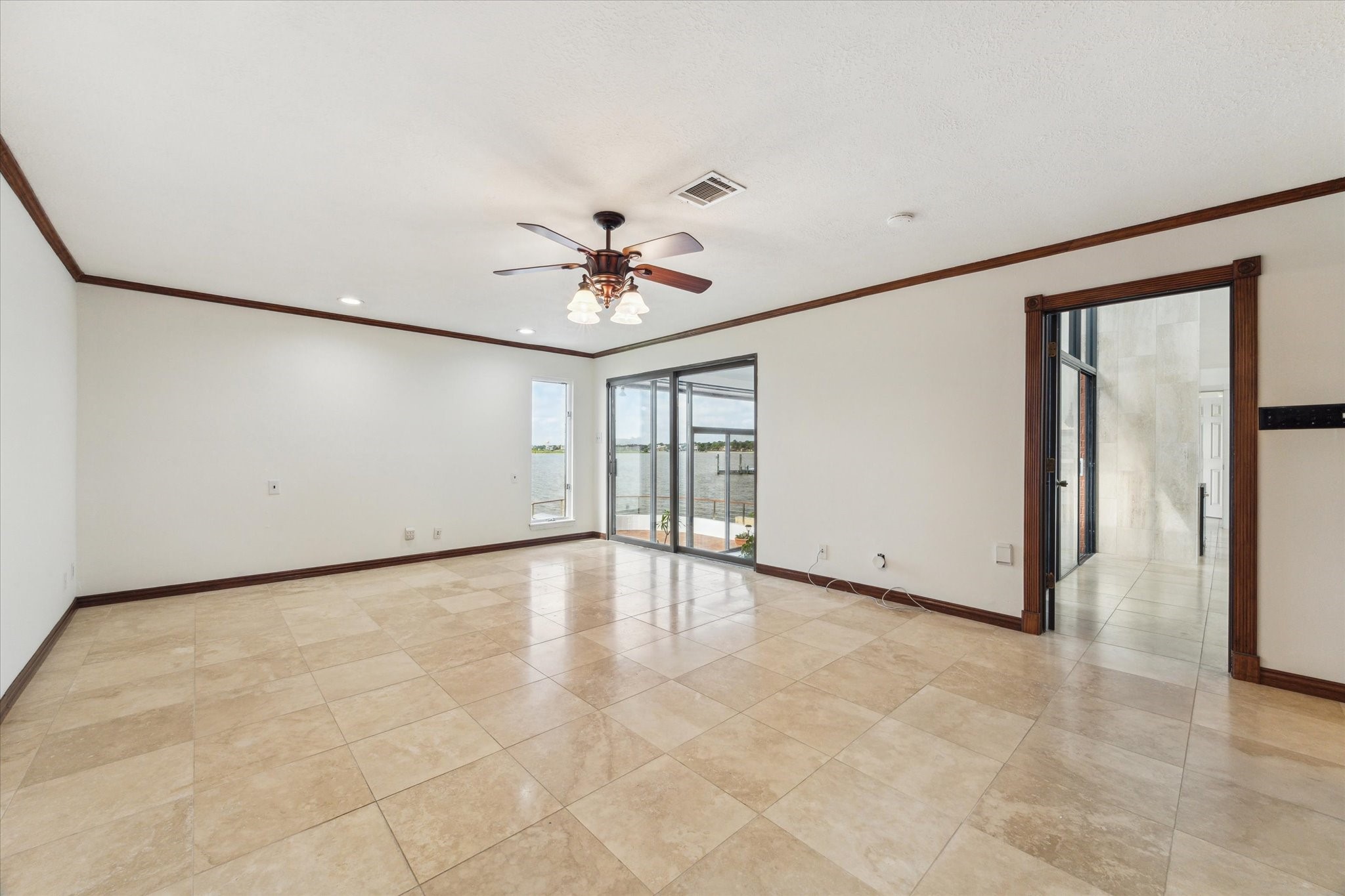 2414 Baycrest Drive Houston, TX 77058 - Photo 30 of 48 an empty room with chandelier fan and windows