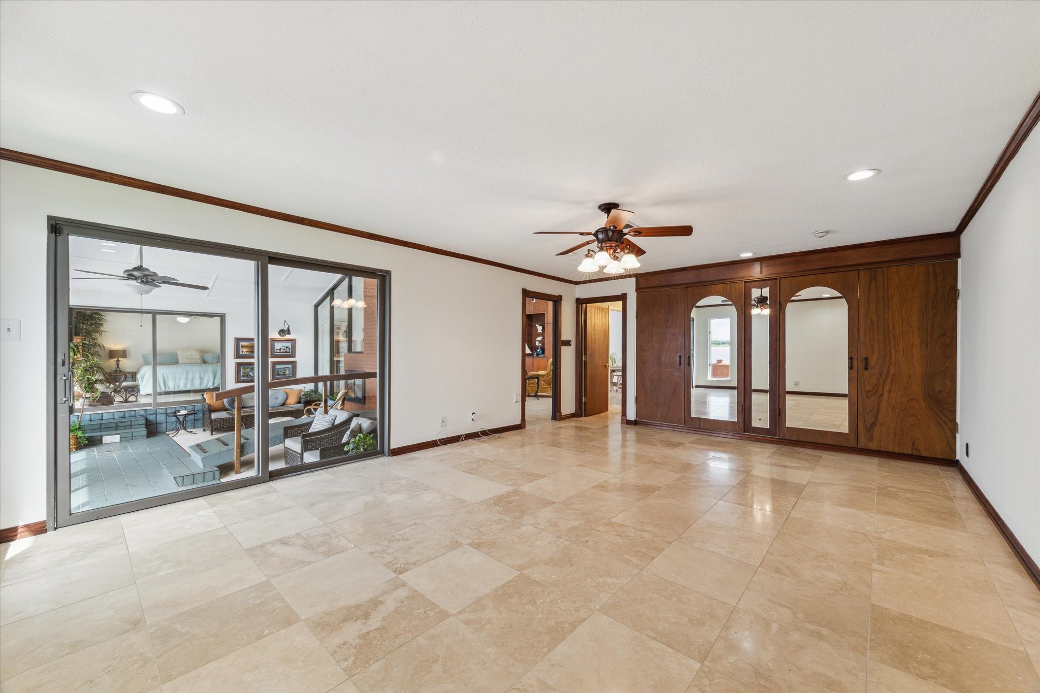 2414 Baycrest Drive Houston, TX 77058 - Photo 31 of 48 an empty room with chandelier fan and windows
