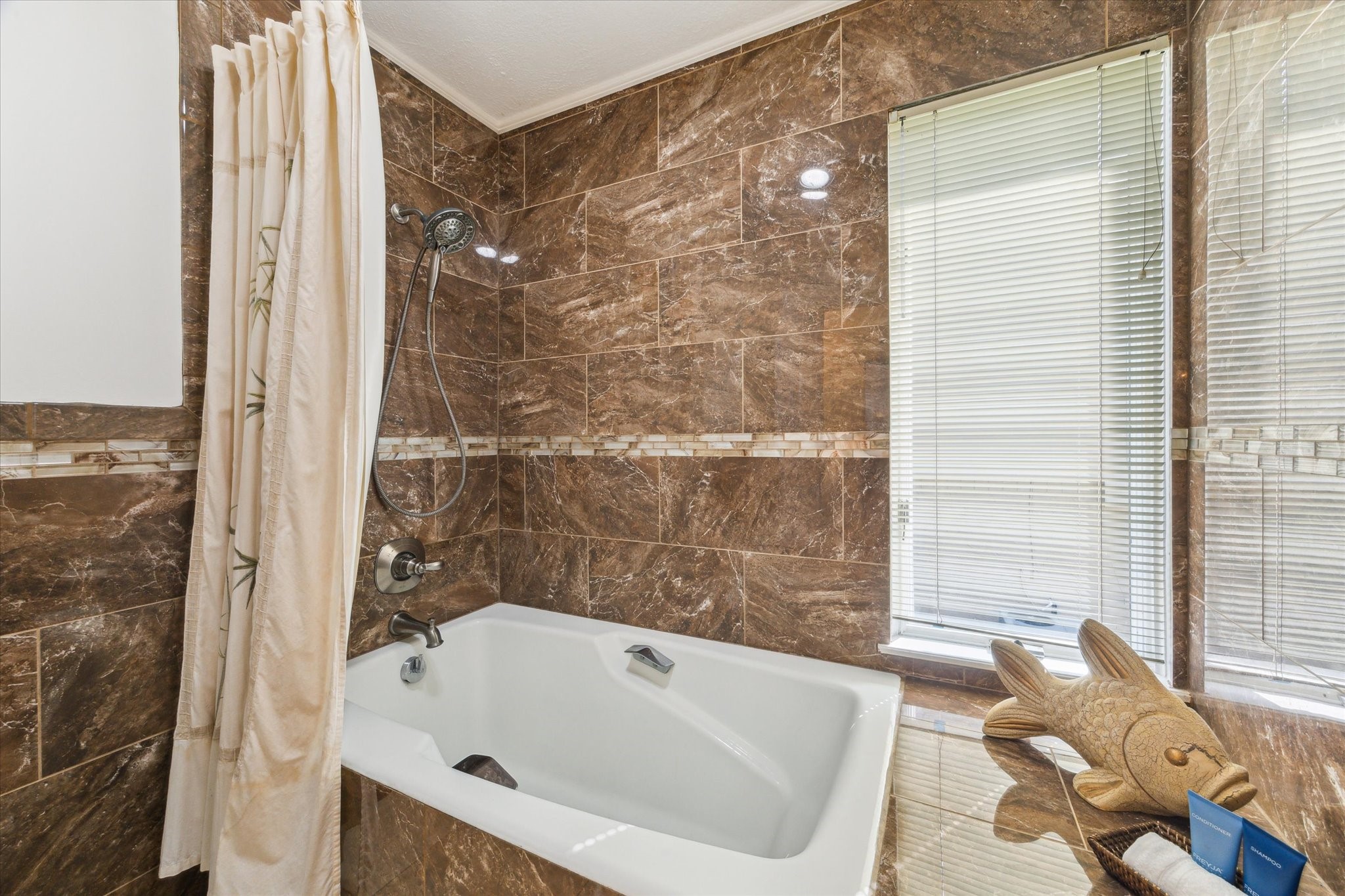 2414 Baycrest Drive Houston, TX 77058 - Photo 33 of 48 a bathroom with a tub and a shower