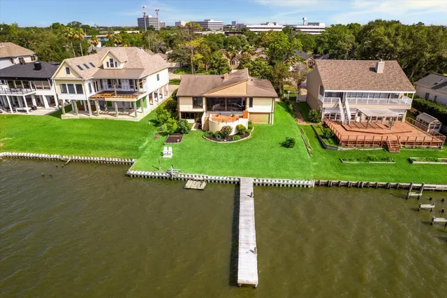 an aerial view of a house with a garden and lake view