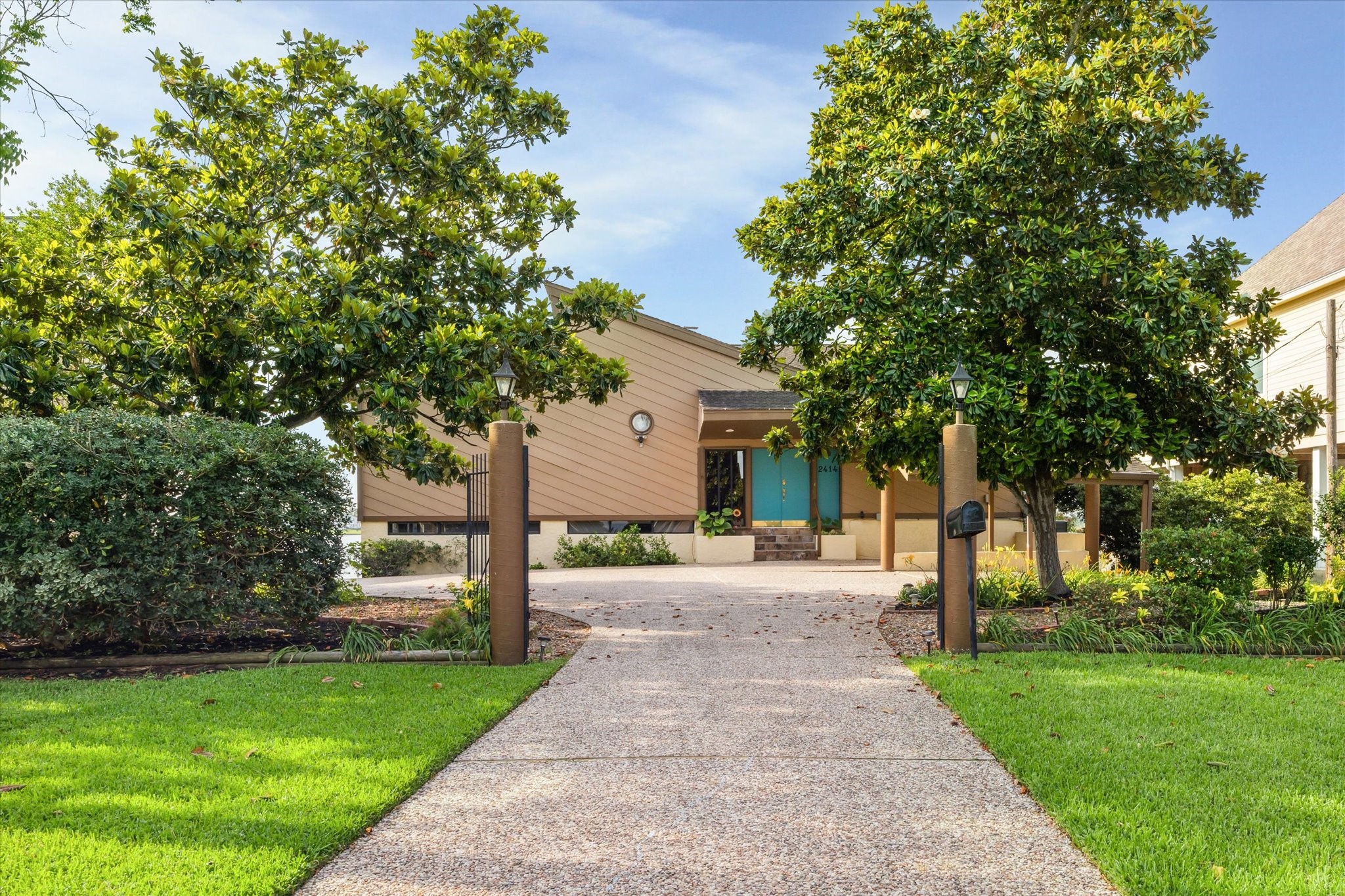 2414 Baycrest Drive Houston, TX 77058 - Photo 7 of 48 a front view of a house with a yard and trees