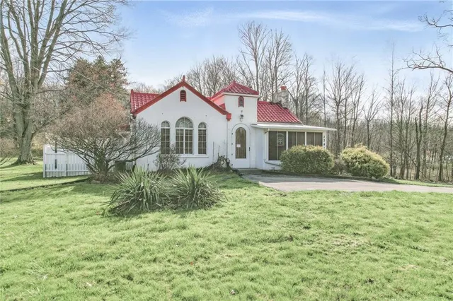 a front view of a house with garden