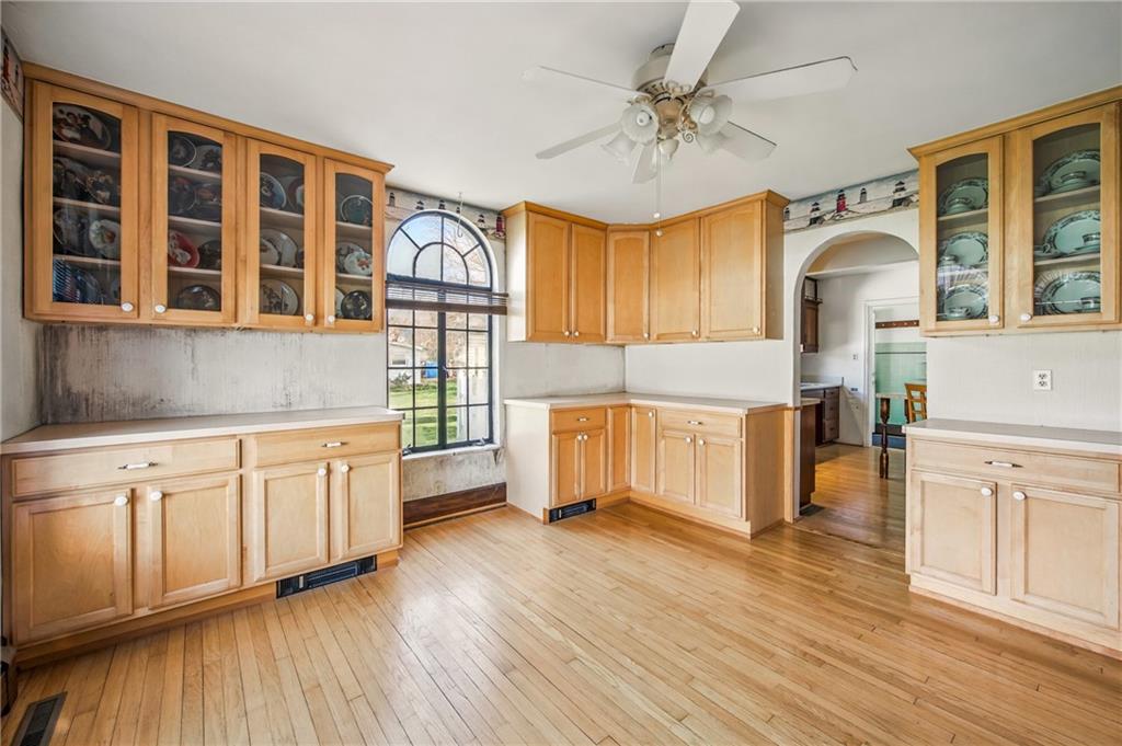 2341 South Hermitage Road Hermitage, PA 16148 - Photo 16 of 28 a kitchen with cabinets wooden floor and a fireplace