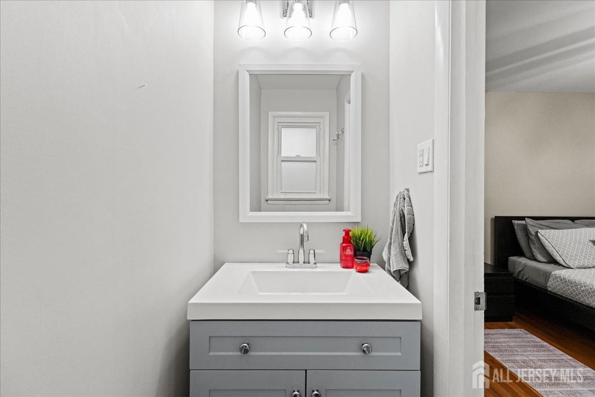 45 Lumar Road Lawrence Township, NJ 08648 - Photo 25 of 29 a bathroom with a sink and a mirror