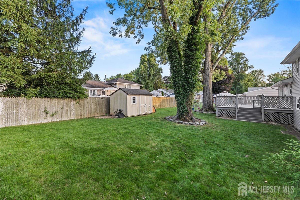 45 Lumar Road Lawrence Township, NJ 08648 - Photo 26 of 29 a view of a backyard with large trees and wooden fence