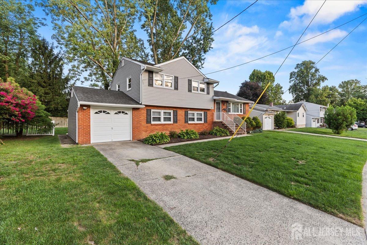 45 Lumar Road Lawrence Township, NJ 08648 - Photo 3 of 29 a front view of a house with a yard and garage