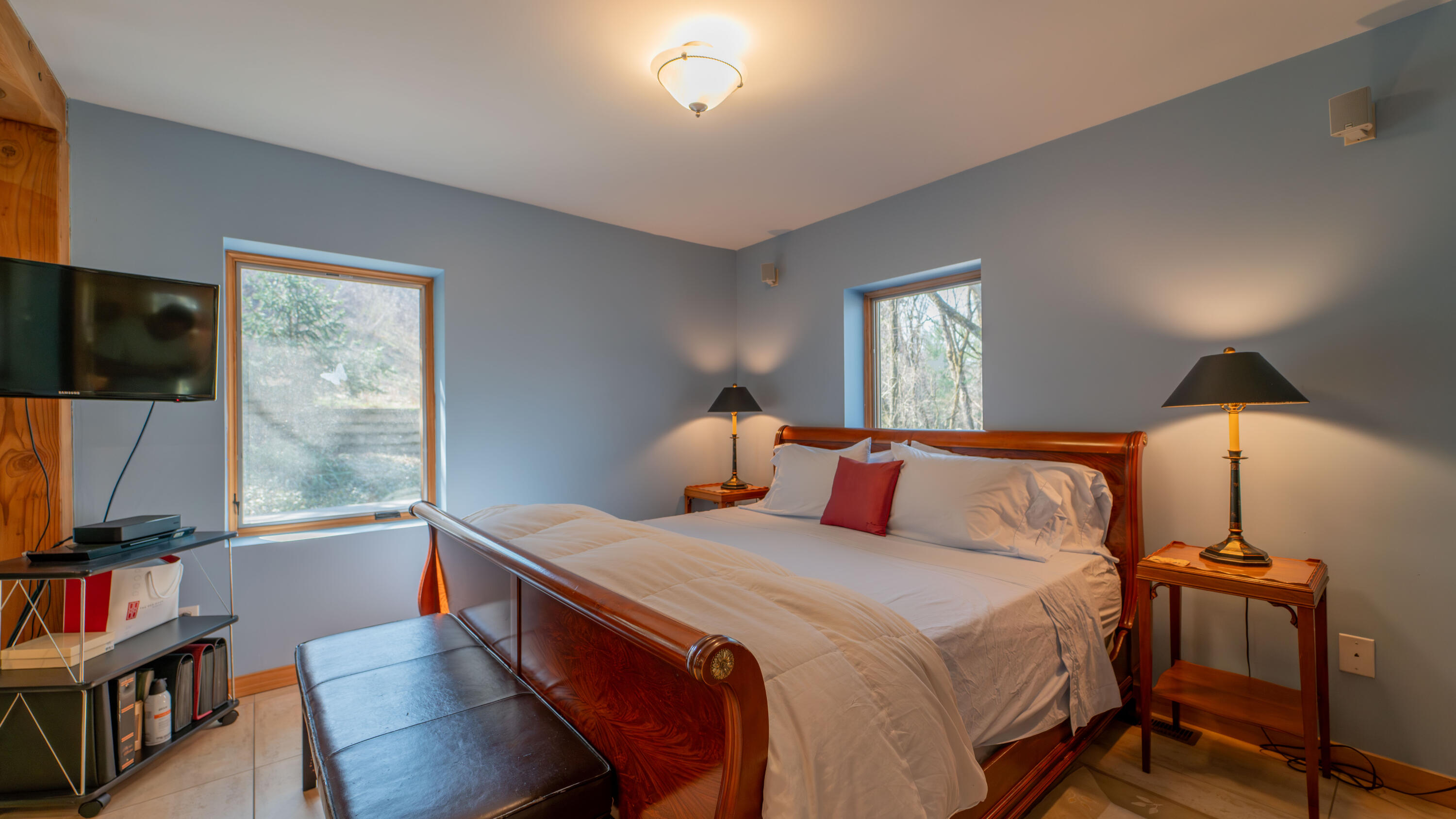 21 Turret Road Ogden Dunes, IN 46368 - Photo 17 of 32 a bedroom with a bed and a flat tv screen on a dresser