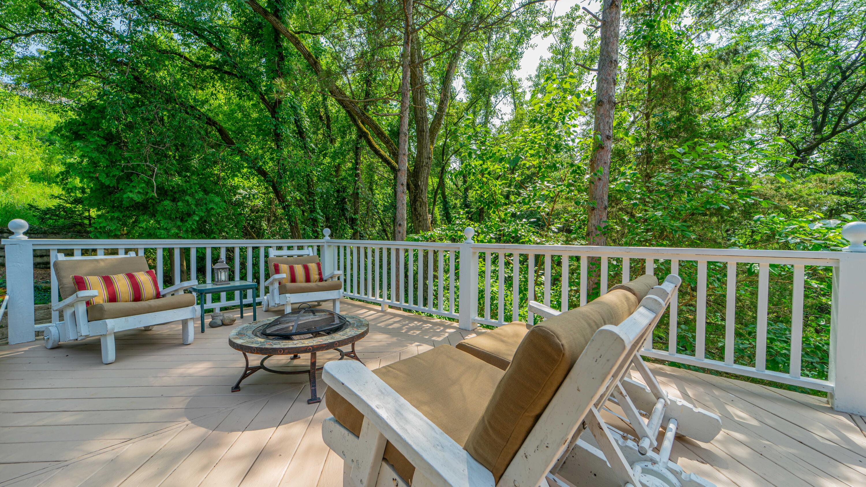 21 Turret Road Ogden Dunes, IN 46368 - Photo 2 of 32 a balcony with wooden floor and outdoor seating