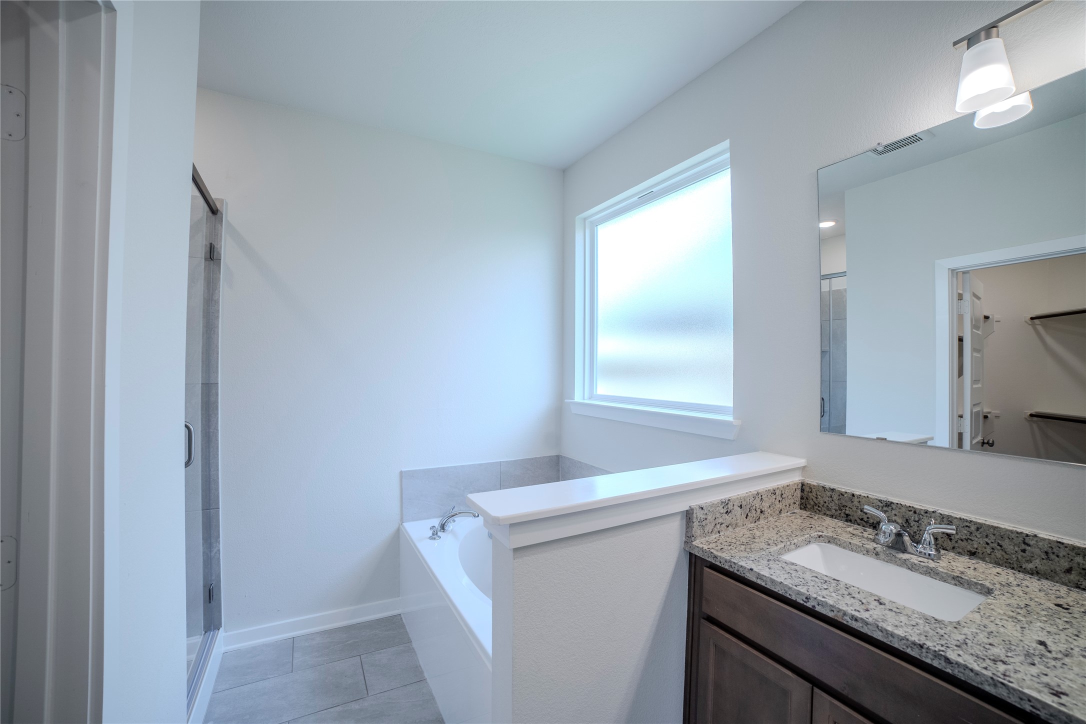 1402 Lk Rdg Drive Brenham, TX 77833 - Photo 28 of 35 a bathroom with a granite countertop sink and a mirror