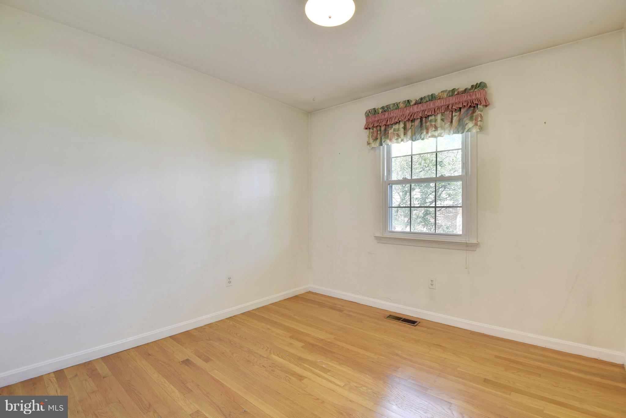 20601 Top Ridge Drive Boyds, MD 20841 - Photo 11 of 26 an empty room with wooden floor and windows