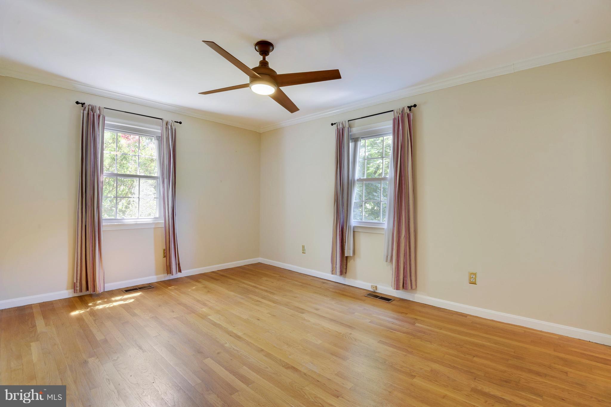 20601 Top Ridge Drive Boyds, MD 20841 - Photo 15 of 26 an empty room with wooden floor fan and windows