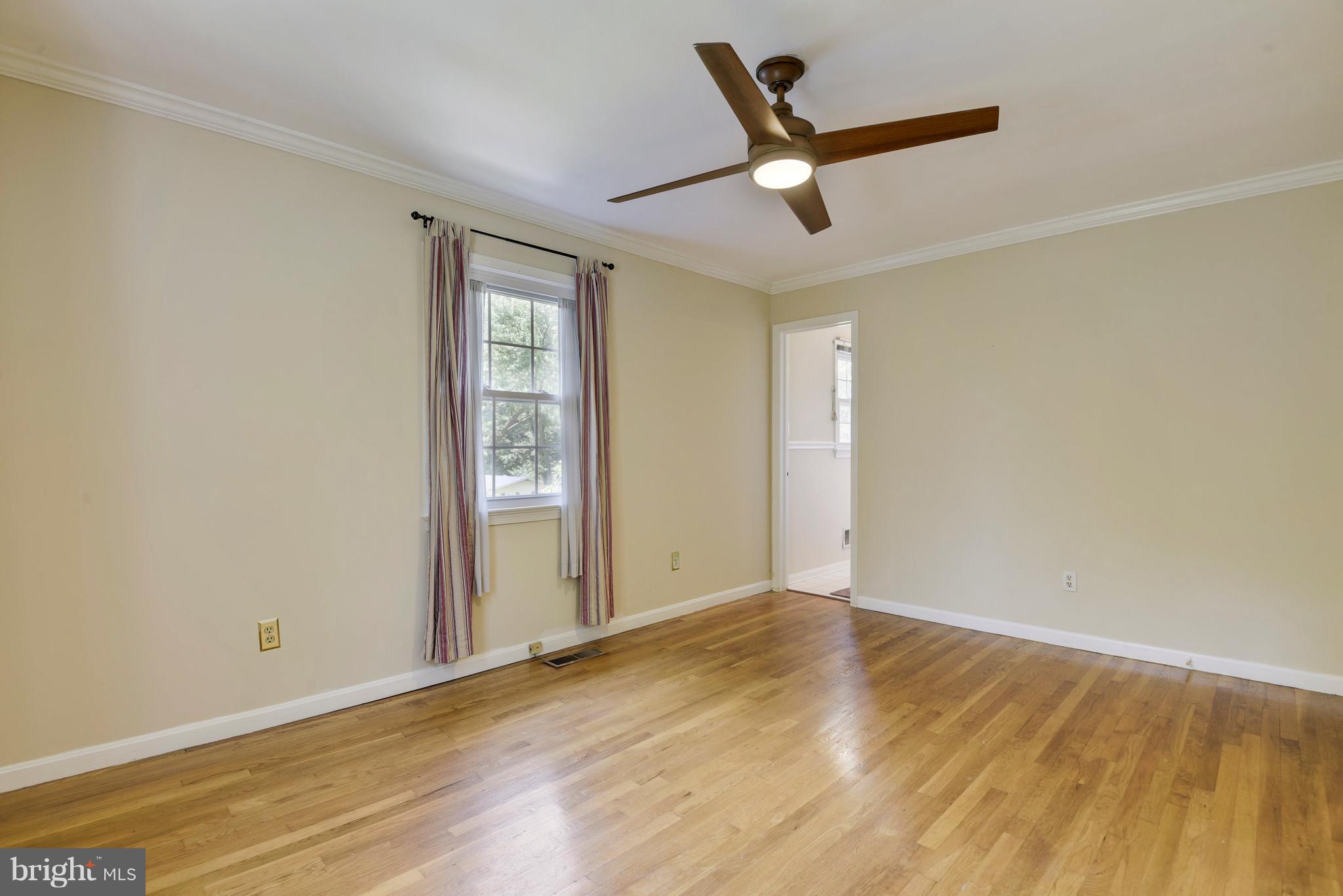 20601 Top Ridge Drive Boyds, MD 20841 - Photo 16 of 26 an empty room with wooden floor fan and windows
