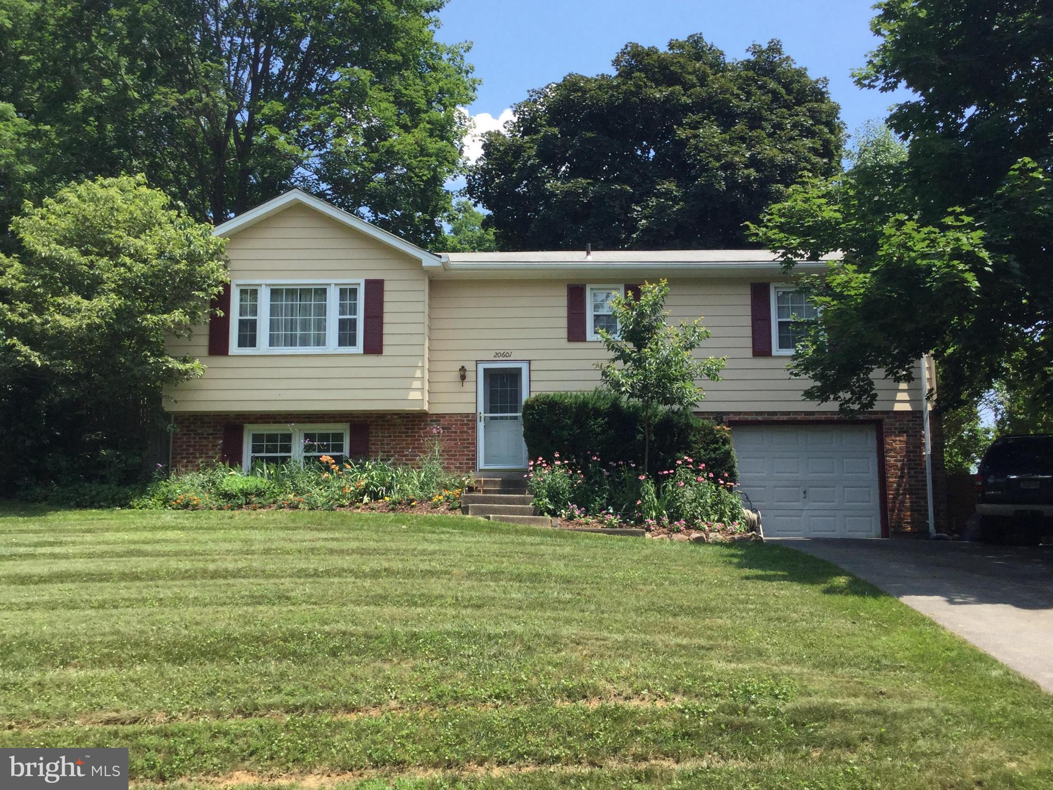 20601 Top Ridge Drive Boyds, MD 20841 - Photo 20 of 26 a front view of a house with a garden