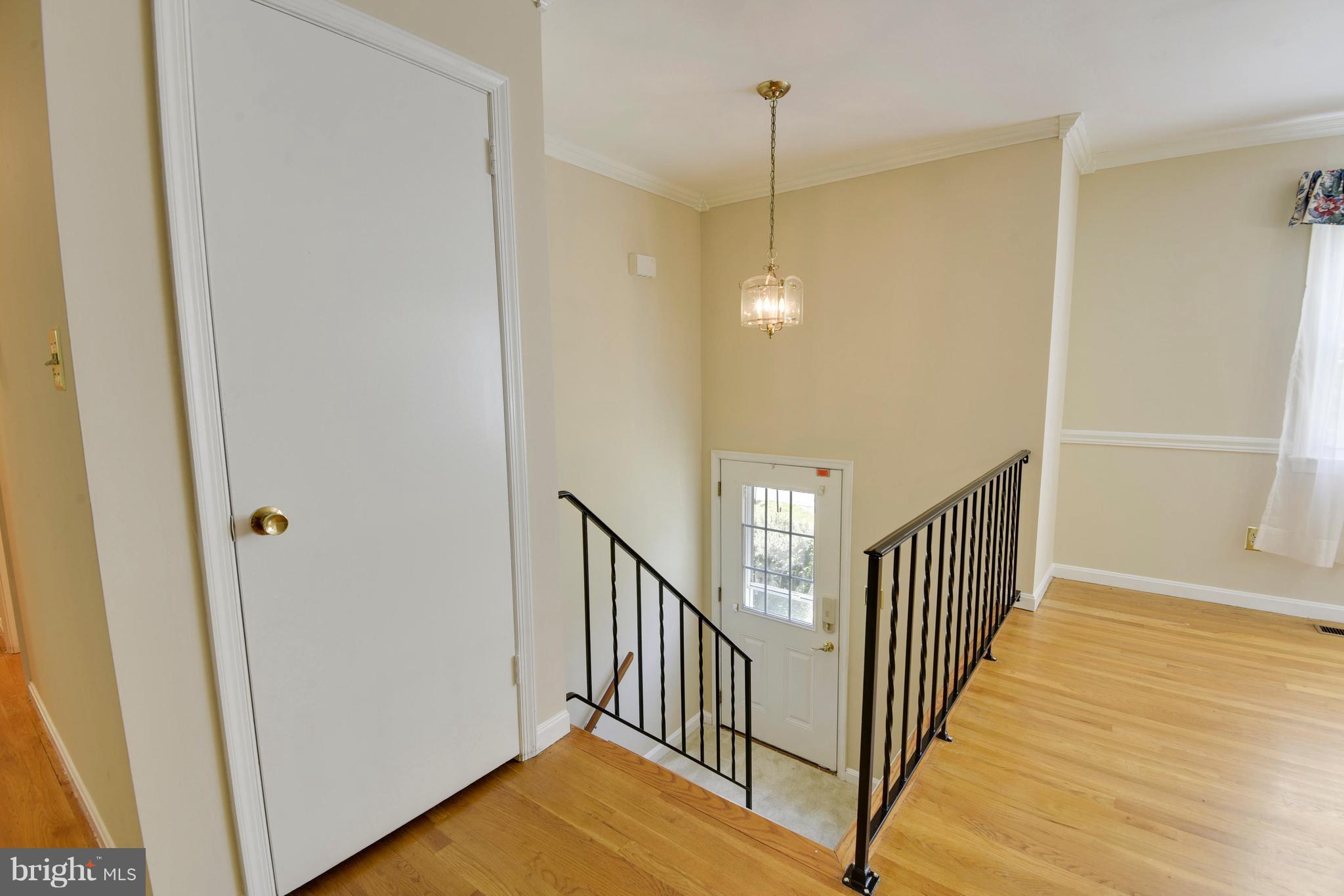 20601 Top Ridge Drive Boyds, MD 20841 - Photo 4 of 26 a view of a hallway with wooden floor and staircase