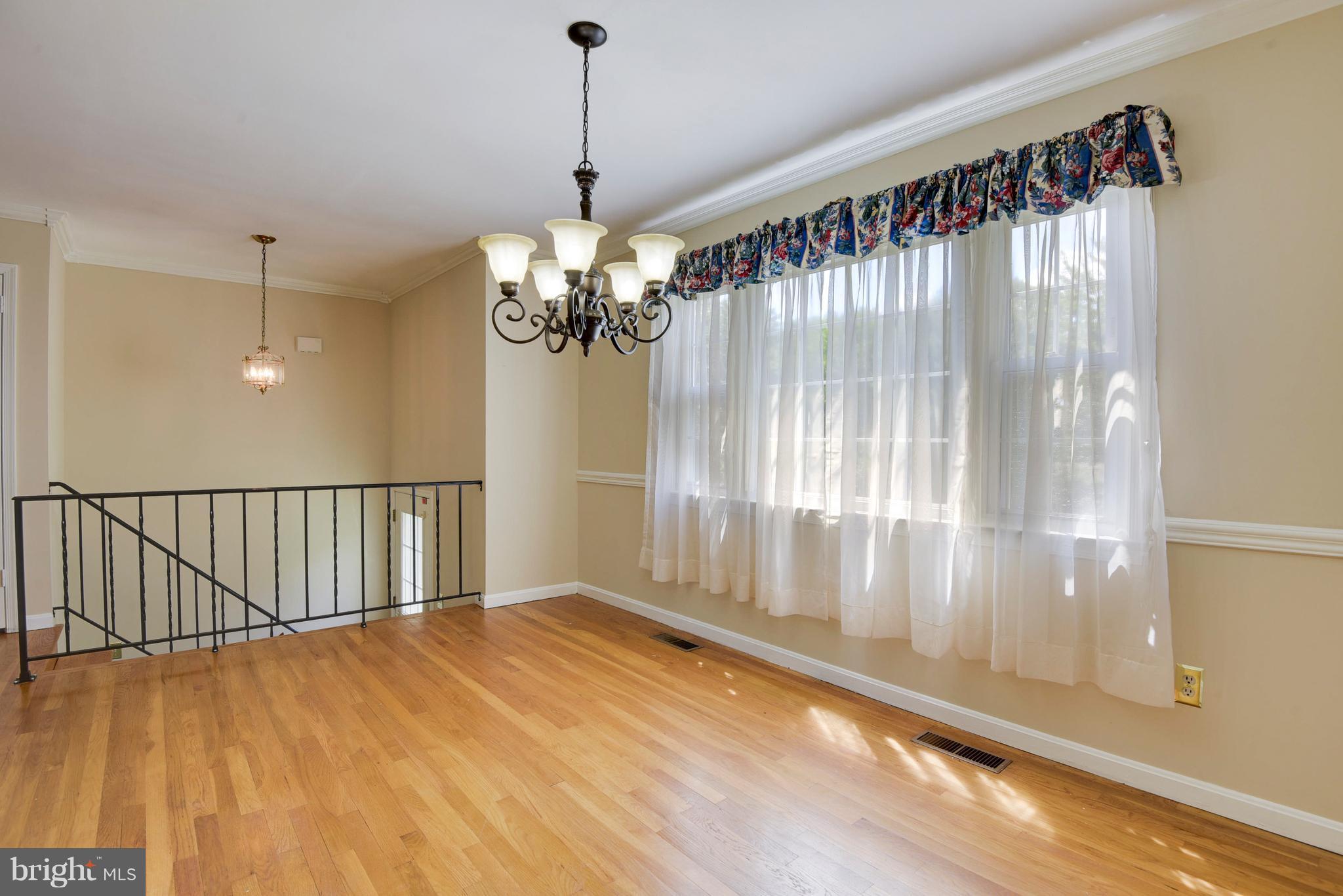20601 Top Ridge Drive Boyds, MD 20841 - Photo 5 of 26 a view of an empty room with wooden floor and a window