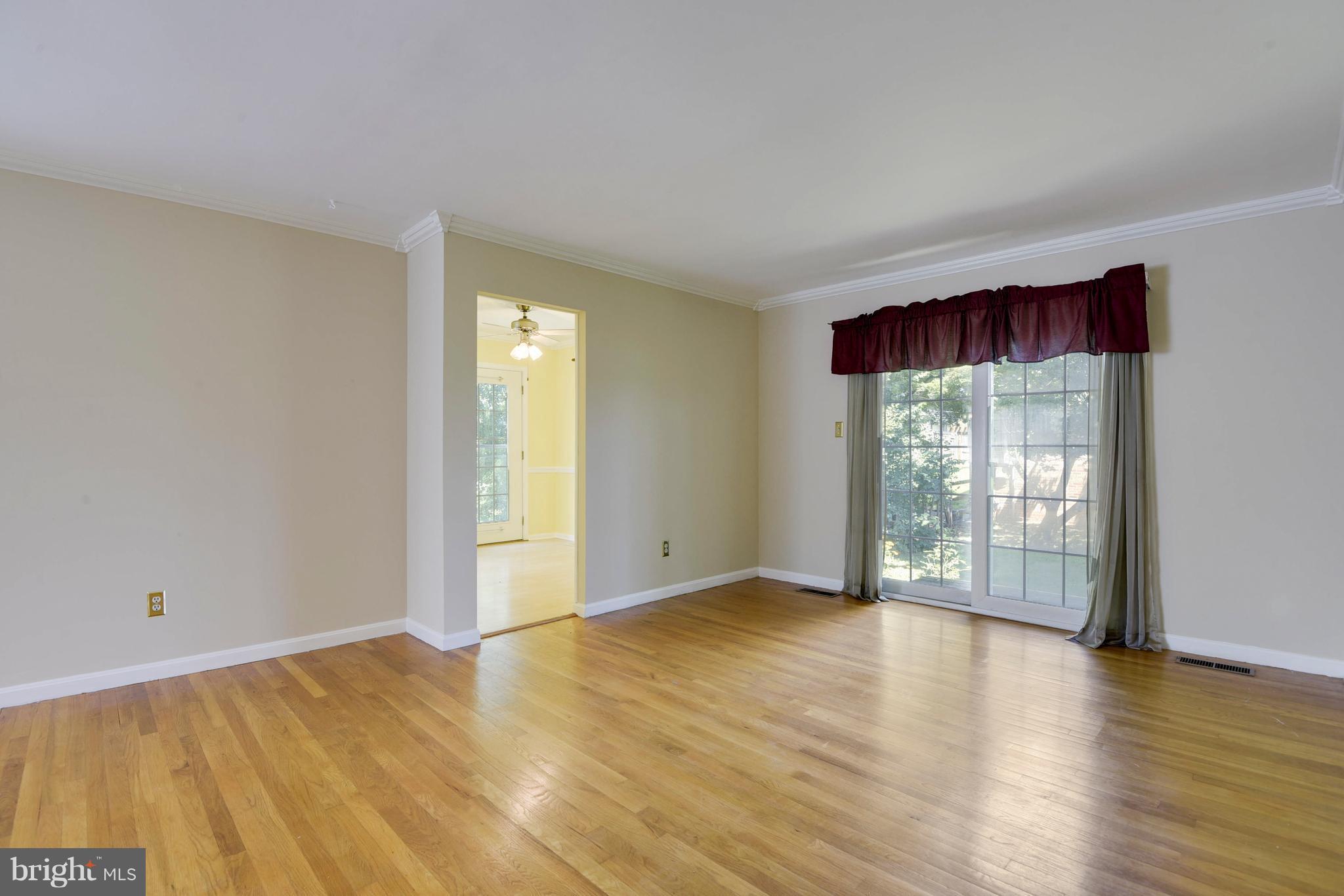 20601 Top Ridge Drive Boyds, MD 20841 - Photo 7 of 26 a view of an empty room with wooden floor and a window