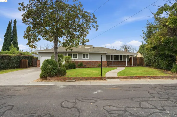 a yellow house with trees in front of it