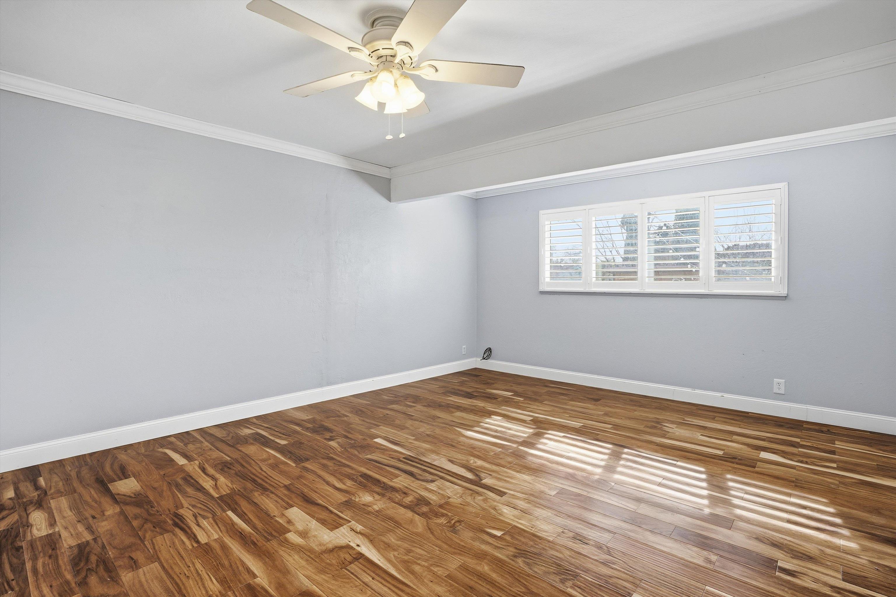 4054 Kimberly Place Concord, CA 94521 - Photo 11 of 16 Bedroom 2 featuring ornamental molding, a ceiling fan, and wood finished floors.
