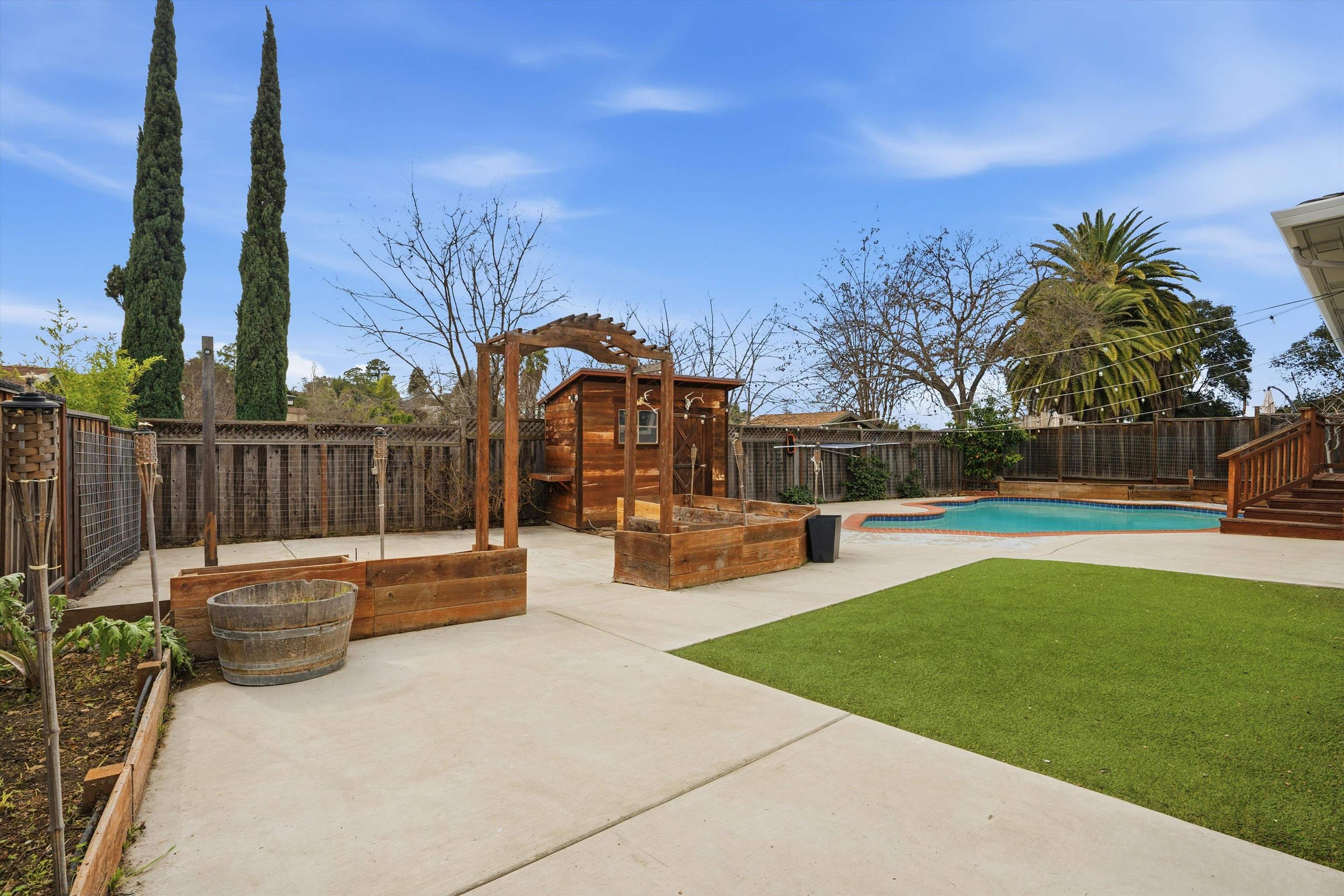 4054 Kimberly Place Concord, CA 94521 - Photo 14 of 16 Fenced backyard featuring concrete hardscape, raised garden boxes, turf grass, pool, and a patio area