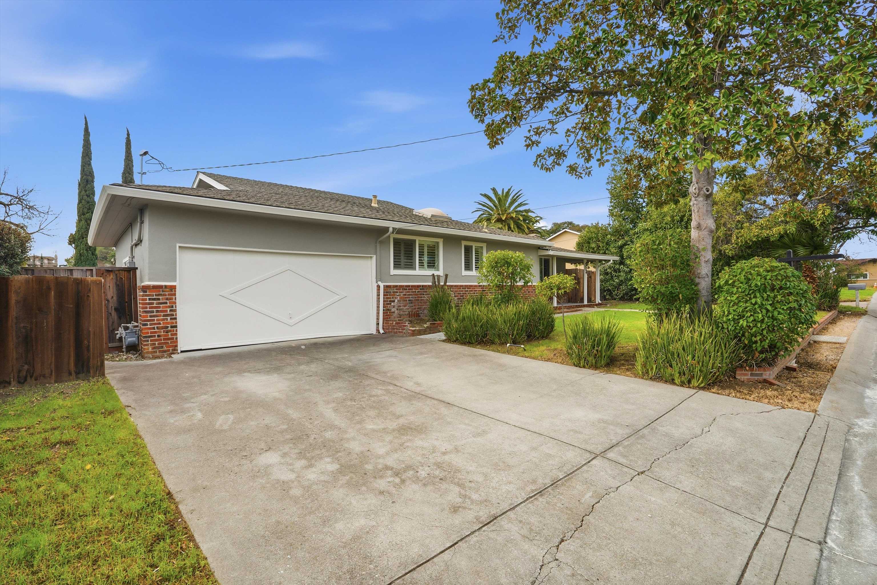 4054 Kimberly Place Concord, CA 94521 - Photo 2 of 16 Ranch-style house with brick siding, stucco siding, concrete driveway, and a garage