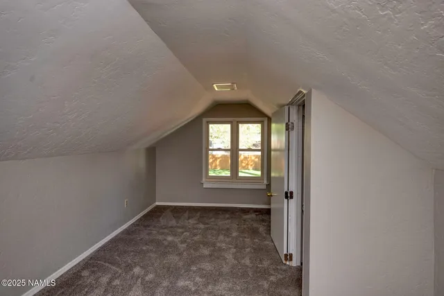 an empty room with a empty space and windows