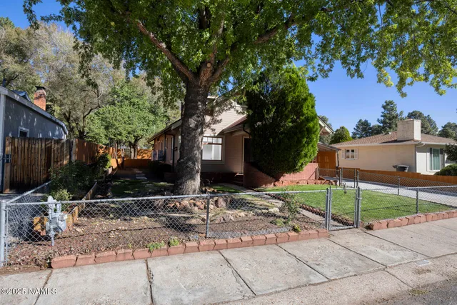 a view of a patio with a table and chairs under an umbrella
