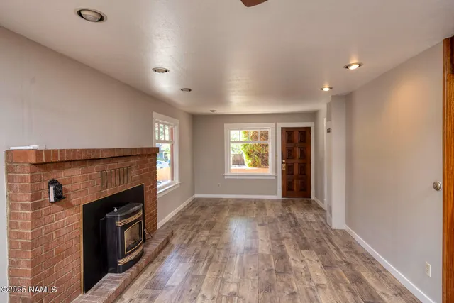 a view of an empty room and a fireplace
