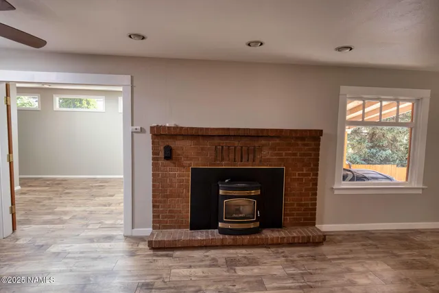 an empty room with a fireplace and window