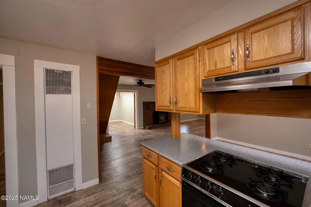 a kitchen with granite countertop a stove and a refrigerator