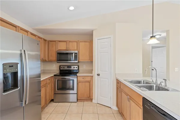 a kitchen with a sink and stainless steel appliances
