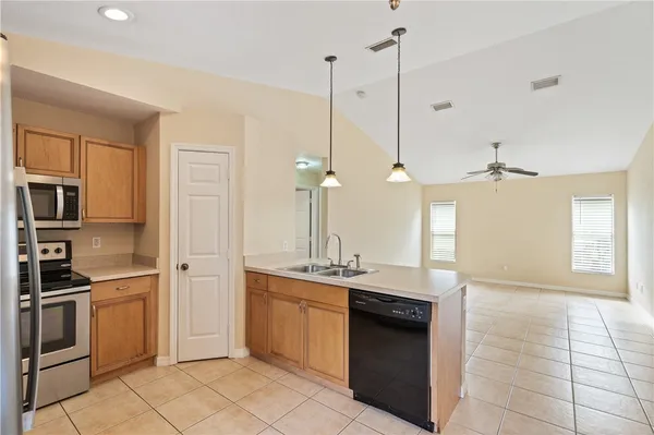 a view of a kitchen with sink and window