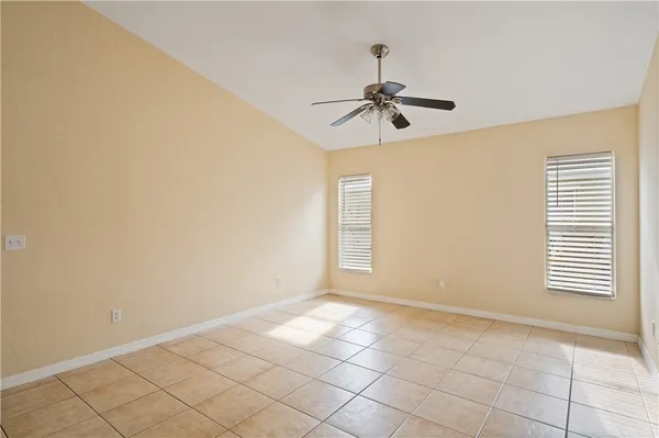 a view of room with hardwood floor and fan