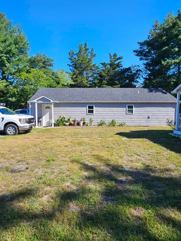 a view of a house with swimming pool and a yard