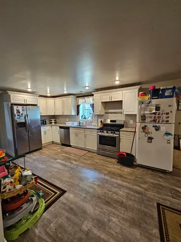a kitchen with stainless steel appliances a stove a refrigerator and a sink