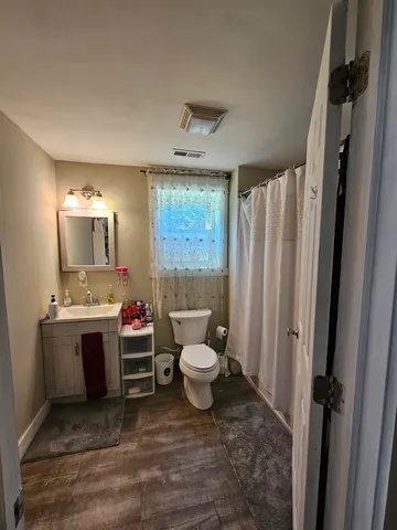 a bathroom with a toilet sink and mirror