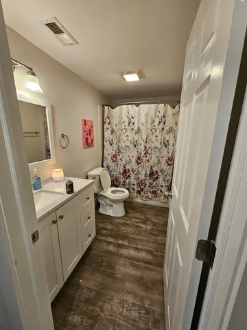 a bathroom with sink toilet and shower