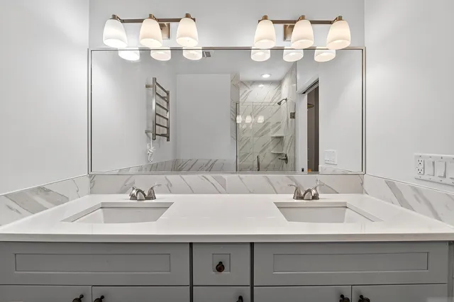 a bathroom with a sink vanity and a mirror