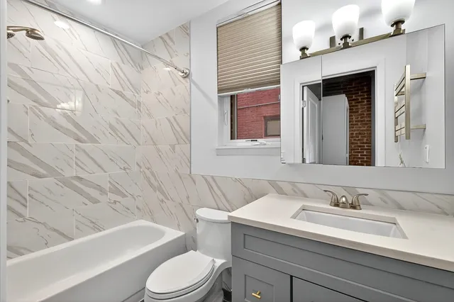 a bathroom with a sink a toilet and bathtub