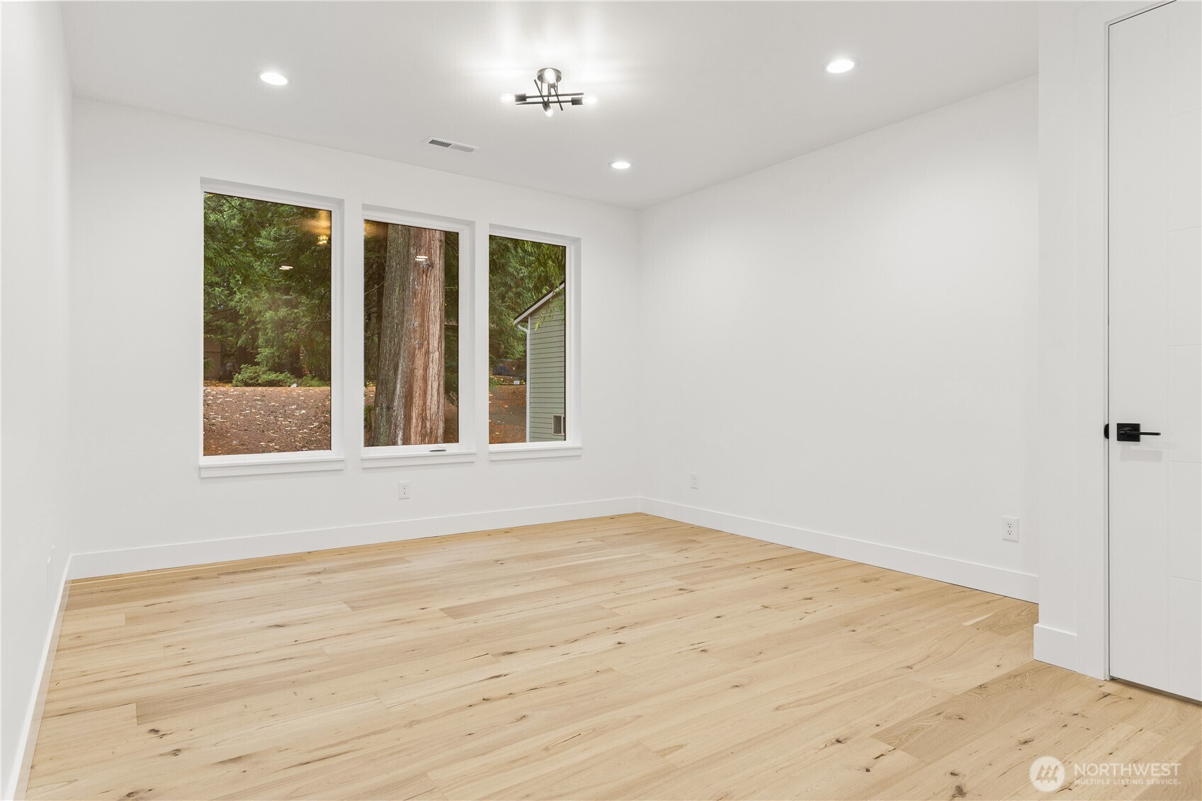 3 Acorn Place Bellingham, WA 98229 - Photo 28 of 35 an empty room with wooden floor and windows