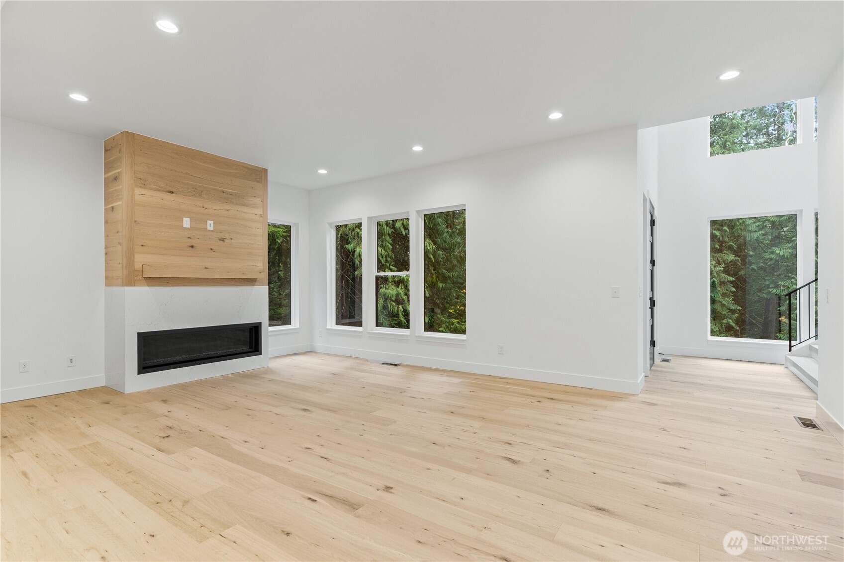 3 Acorn Place Bellingham, WA 98229 - Photo 4 of 35 a view of an empty room with a window and wooden floor