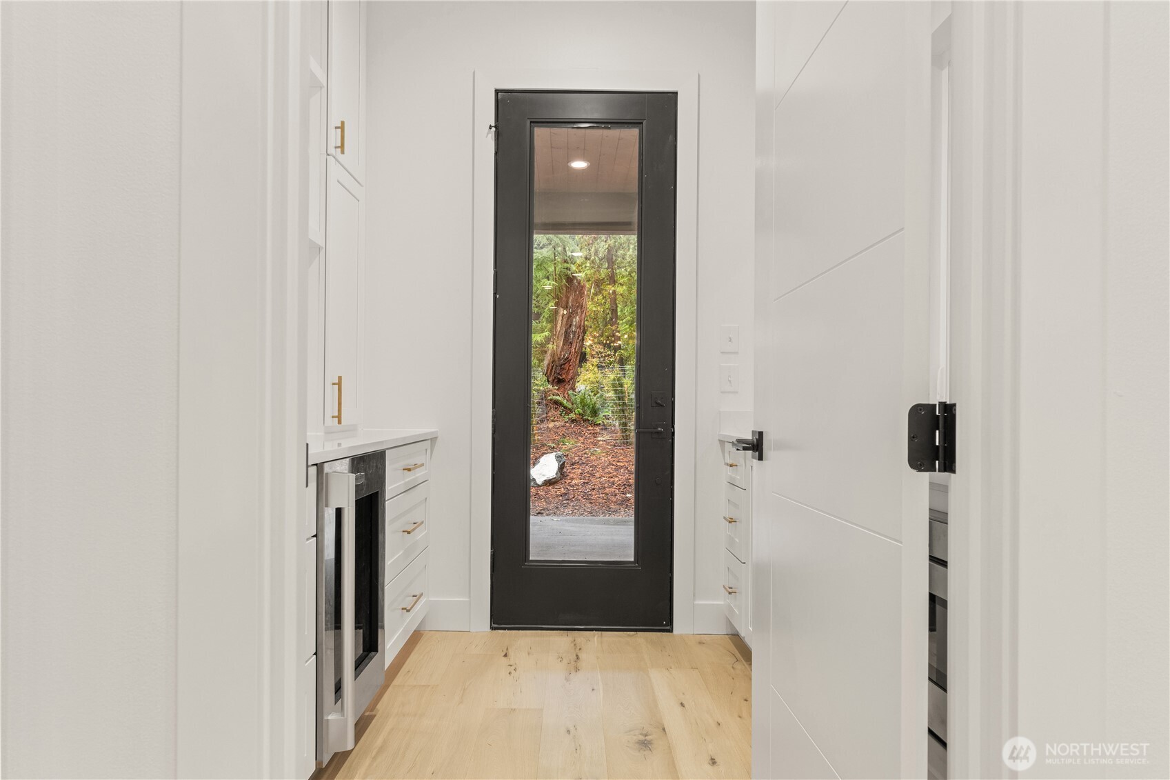 3 Acorn Place Bellingham, WA 98229 - Photo 8 of 35 a view of a hallway with wooden floor and a bathroom