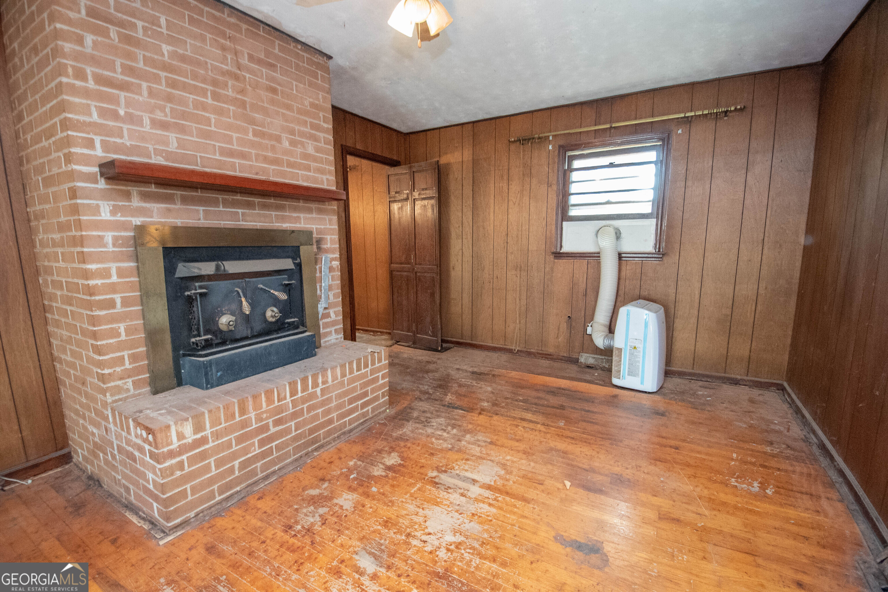 980 Grandma Branch Road Grantville, GA 30220 - Photo 7 of 33 a view of an empty room with window and fire place